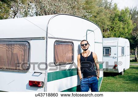 Man leaning against caravan View Large Photo Image Stock Image - Man leaning against caravan. Fotosearch