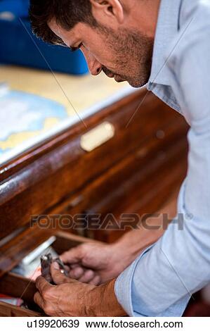 Man looking into drawer View Large Photo Image Stock Photo - Man looking into drawer. Fotosearch