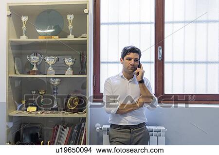 Man on telephone call in office View Large Photo Image Picture - Man on telephone call in office. Fotosearch