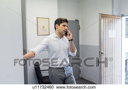 Stock Image - Man on telephone call in office. Fotosearch