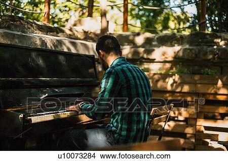Picture - Man playing piano in park. Fotosearch