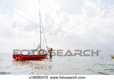 Man preparing sailboat View Large Photo Image Stock Image - Man preparing sailboat. Fotosearch