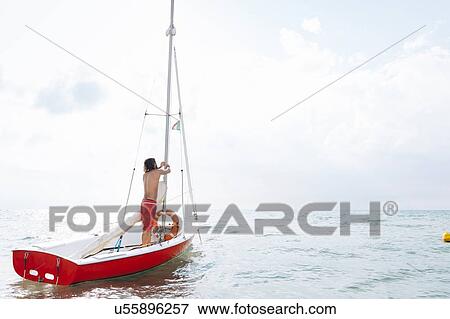 Man preparing sailboat View Large Photo Image Stock Photo - Man preparing sailboat. Fotosearch