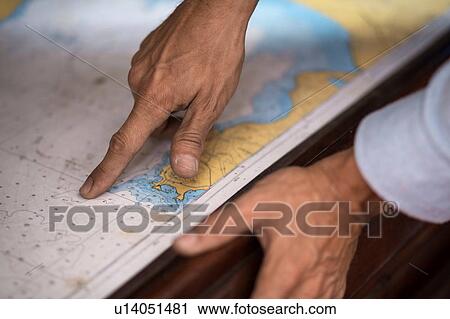 Stock Image - Man reading map. Fotosearch