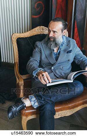 Man reading on armchair View Large Photo Image Stock Image - Man reading on armchair. Fotosearch