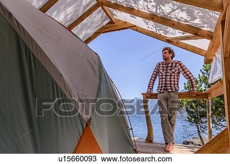 Man relaxing beside tent, Johnstone Strait, Telegraph Cove, Canada View Large Photo Image Stock Image - Man relaxing beside tent, Johnstone Strait, Telegraph Cove, Canada. Fotosearch