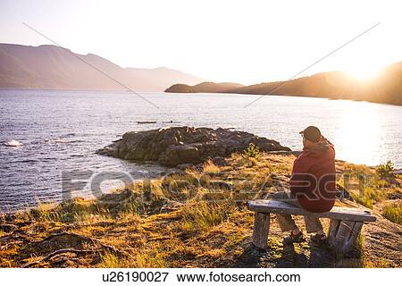 Man relaxing by lakeside, Johnstone Strait, Telegraph Cove, Canada View Large Photo Image Stock Photo - Man relaxing by lakeside, Johnstone Strait, Telegraph Cove, Canada. Fotosearch