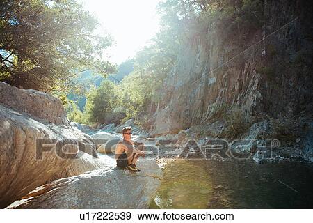 Man relaxing by stream, Arezzo, Toscana, Italy View Large Photo Image Stock Photo - Man relaxing by stream, Arezzo, Toscana, Italy. Fotosearch