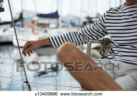Stock Photograph - Man relaxing on sailboat, Cape Town, Western Cape, South Africa. Fotosearch
