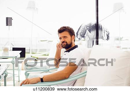 Man relaxing on terrace chair View Large Photo Image Stock Photo - Man relaxing on terrace chair. Fotosearch