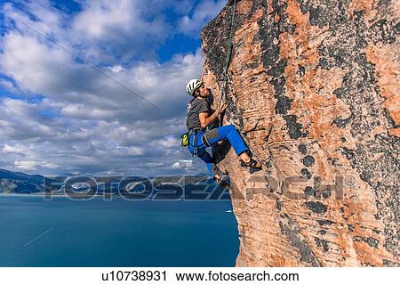 Stock Image - Man rock climbing, Narsaq, Vestgronland, South Greenland. Fotosearch