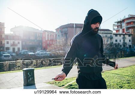Picture - Man skipping in park. Fotosearch