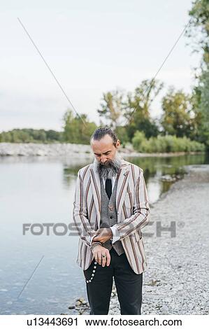 Man standing by lake View Large Photo Image Stock Image - Man standing by lake. Fotosearch