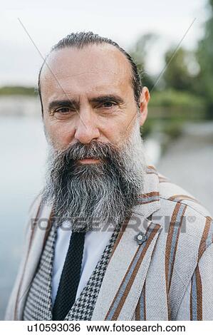 Stock Photograph - Man standing by lake. Fotosearch