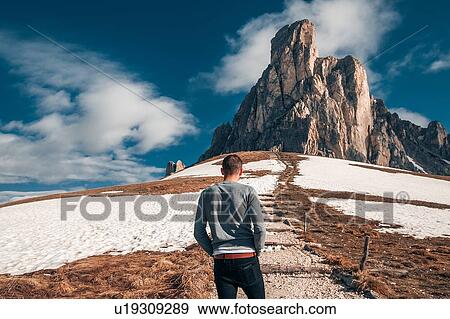 Stock Photo - Man standing steps to rock, Francenigo, Veneto, Italy. Fotosearch