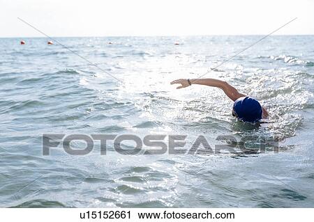 Man swimming in sea View Large Photo Image Stock Image - Man swimming in sea. Fotosearch