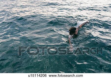 Man swimming in sea View Large Photo Image Stock Photograph - Man swimming in sea. Fotosearch