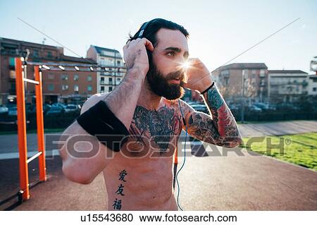 Man taking break in outdoor gym View Large Photo Image Stock Image - Man taking break in outdoor gym. Fotosearch