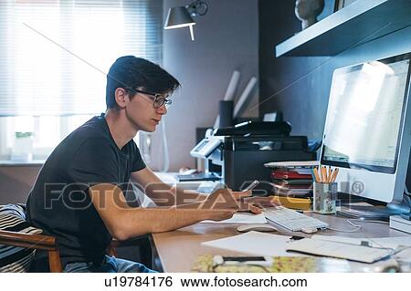 Man using cellphone at desk View Large Photo Image Stock Photograph - Man using cellphone at desk. Fotosearch