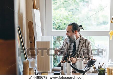 Man working in his studio View Large Photo Image Stock Photo - Man working in his studio. Fotosearch
