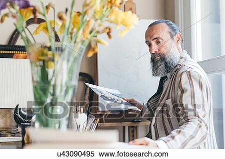 Man working in his studio View Large Photo Image Stock Photography - Man working in his studio. Fotosearch