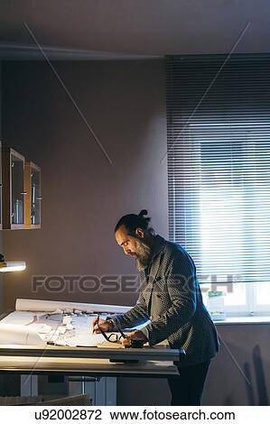 Stock Image - Man working in home office. Fotosearch
