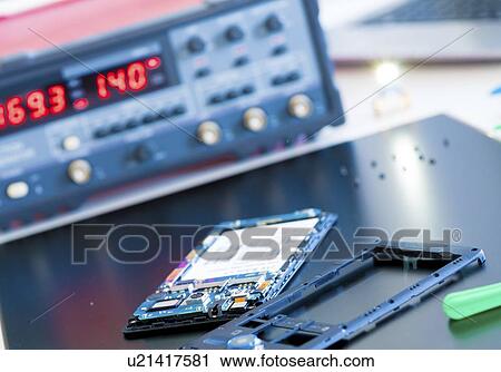 Stock Image - Mobile phone repair.. Fotosearch