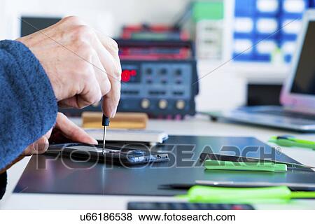 Stock Photo - Mobile phone repair.. Fotosearch