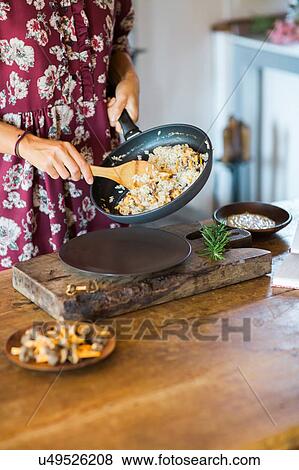 Mushroom risotto in frying pan being served View Large Photo Image Stock Photo - Mushroom risotto in frying pan being served. Fotosearch