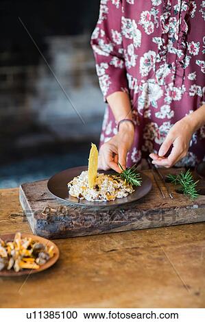 Mushroom risotto on plate being garnished View Large Photo Image Stock Image - Mushroom risotto on plate being garnished. Fotosearch