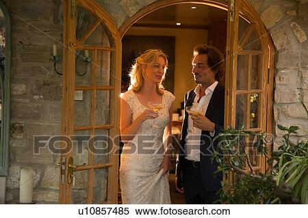 Stock Photography - Newlyweds at wedding reception. Fotosearch