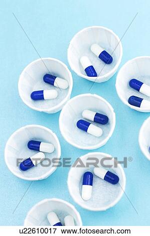 Paper medicine pots with blue and white capsules. View Large Photo Image Stock Photo - Paper medicine pots with blue and white capsules.. Fotosearch