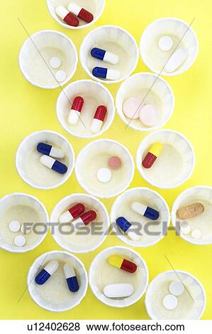 Stock Photo - Paper medicine pots with various pills in them.. Fotosearch