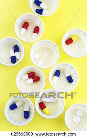 Stock Photo - Paper medicine pots with various pills in them.. Fotosearch