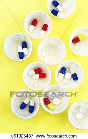 Stock Photo - Paper medicine pots with various pills in them.. Fotosearch