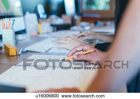 Papers and notes on busy desktop View Large Photo Image Stock Image - Papers and notes on busy desktop. Fotosearch