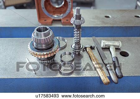 Stock Image - Parts and tools in gearbox factory. Fotosearch