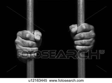 Stock Photography - Person's hands holding prison bars.. Fotosearch