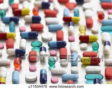 Stock Image - Pills and capsules against a white background.. Fotosearch