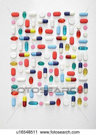 Stock Image - Pills and capsules against a white background.. Fotosearch