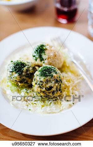 Stock Photo - Plate of Italian food with herb garnish on table, overhead view. Fotosearch