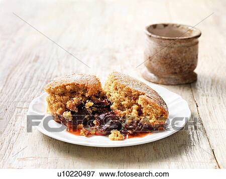 Stock Photo - Plum and ginger sponge pudding dessert. Fotosearch