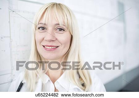 Stock Image - Portrait of female doctor smiling towards camera.. Fotosearch