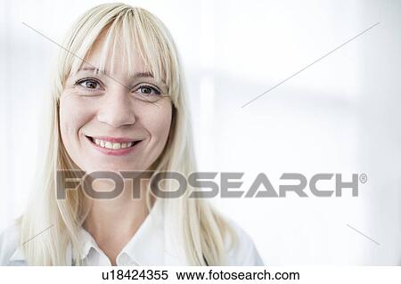 Stock Photography - Portrait of female doctor smiling towards camera.. Fotosearch
