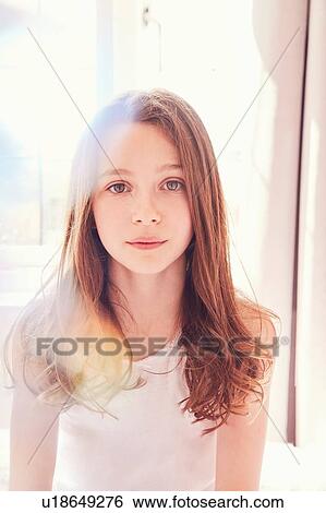 Stock Photograph - Portrait of girl in bright morning light. Fotosearch
