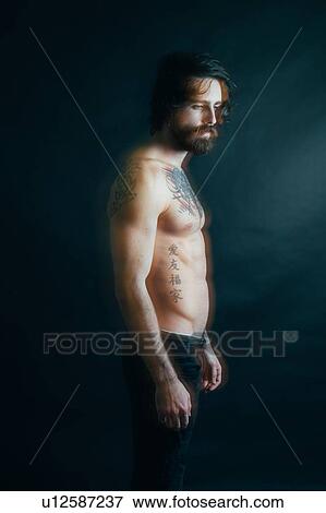 Stock Photo - Portrait of hipster with tattoos. Fotosearch