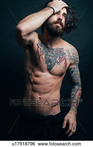 Stock Photograph - Portrait of hipster with tattoos. Fotosearch