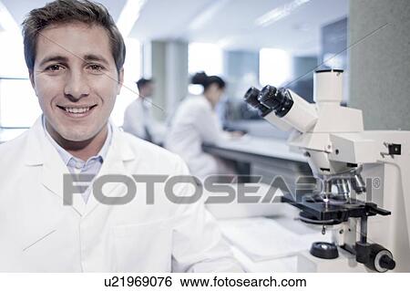 Portrait of male laboratory assistant smiling. View Large Photo Image Stock Photograph - Portrait of male laboratory assistant smiling.. Fotosearch