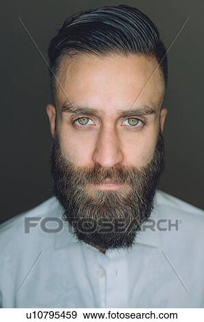 Stock Photo - Portrait of young man with beard, close-up. Fotosearch