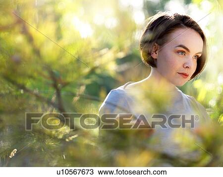 Stock Image - Portrait of young woman in nature. Fotosearch